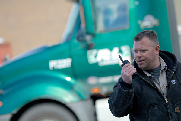 trucker holding two way radio