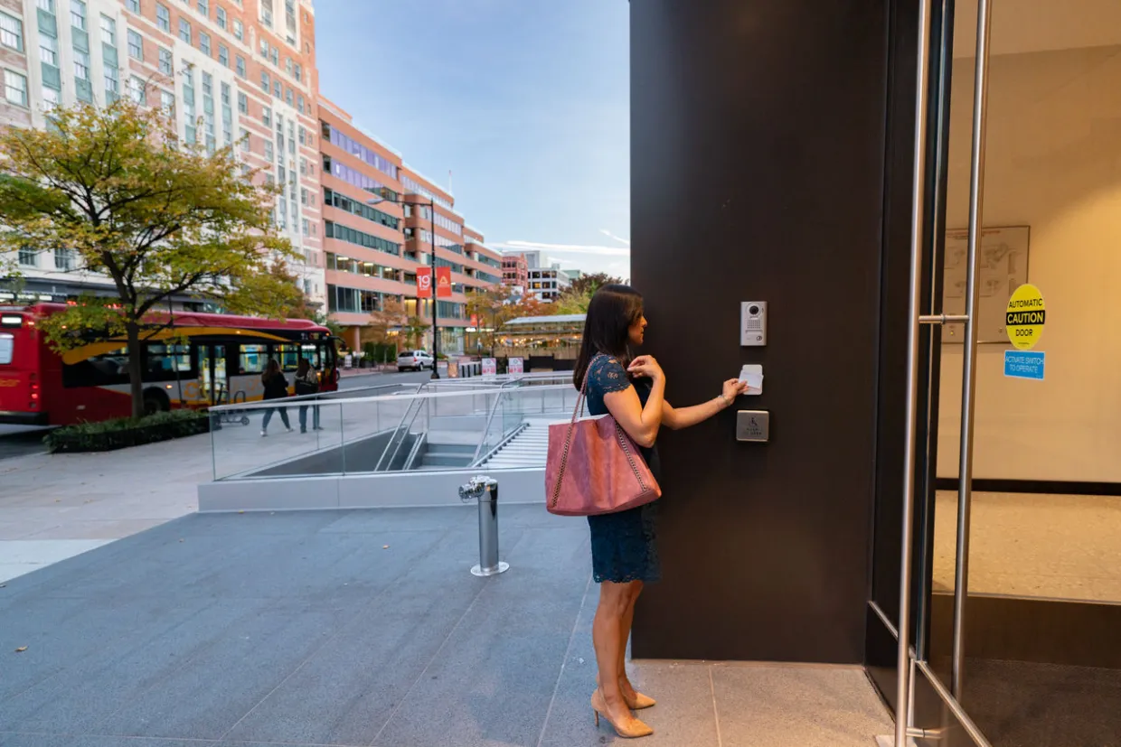 Access Control - woman entering a building with access control