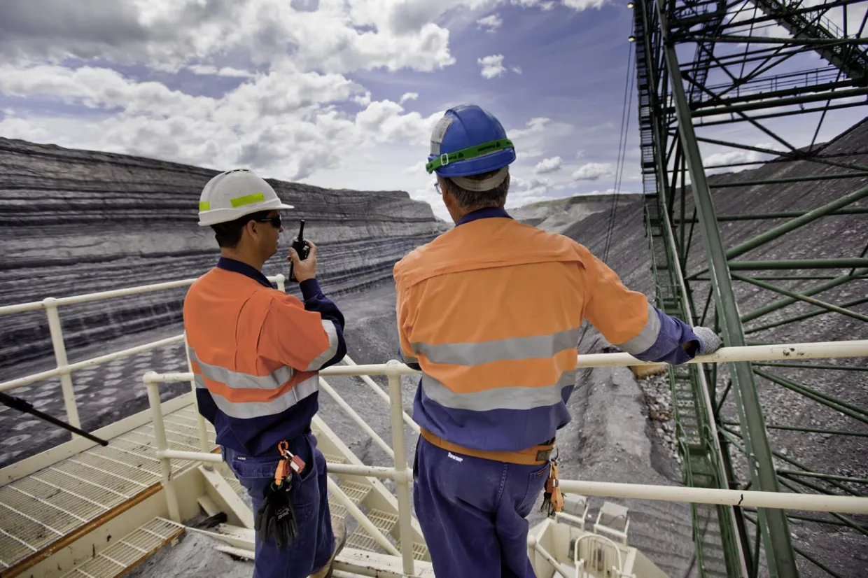 two men coal mine talking on two-way radio